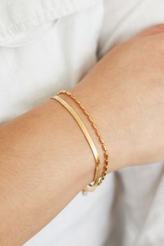 Fall in love with our Lola Layered Bracelet. Featuring a herringbone chain and rice bead chain for the ultimate combination of delicate and minimal. Wear alone or stack with our other stunning bracelets here. Also pairs nicely with Bianca Beaded Bracelet. THE DETAILS Color: PVD 18K Gold Plated Material: Stainless Steel Size: 16cm with 5cm Extender READ HOW TO CARE FOR JEWELRY HERE