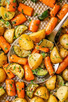 a spoon full of roasted potatoes and carrots