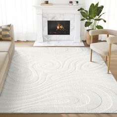 a living room with a white rug and fireplace