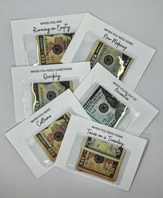 five envelopes with money in them on a table