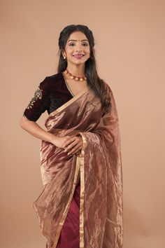 Experience the perfect fusion of tradition and modernity with this Exquisite Half and Half Maroon and Zari Tissue Maheshwari Silk Cotton Saree. Crafted with a delicate blend of silk and cotton, this saree offers a lightweight drape while exuding rich sophistication. The striking half-and-half design pairs deep maroon on one side with shimmering zari tissue on the other, creating a stunning visual contrast. Ideal for weddings, festive gatherings, and special occasions, this saree seamlessly merges comfort with elegance. The intricate zari work on the tissue side enhances the saree's luxurious appeal, while the rich maroon side lends a bold, regal touch. The soft, breathable texture of the Maheshwari silk cotton ensures all-day comfort without compromising style. Pair it with statement gold Deep Maroon, Silk Cotton Sarees, Half And Half, Zari Work, Blouse Fabric, Cotton Saree, Salwar Kameez, Festival Season, Ready To Wear