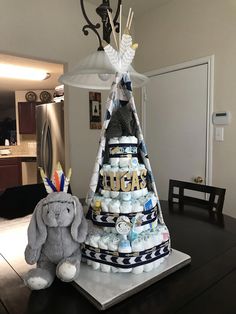 a diaper cake with an elephant sitting next to it on top of a table