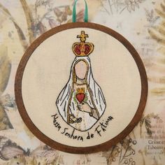 a cross stitch ornament with the image of mary ann de flaum