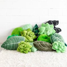 a pile of green plants sitting on top of a white rug