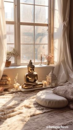 a buddha statue sitting on top of a bed next to a window