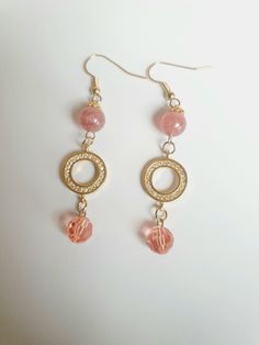 Soft pink vibes are calming and nurturing. Strawberry quartz produces exactly that. This stunning handmade pair you're looking at comprises one 8 mm strawberry quartz and one pink Swarovski crystal on each piece, decorated with a gold Swarovski -studded disk and floral gold bead caps. The result is a pair of stylish ear rings that accentuates your matching attire.  This beauty is 5 cm long from the base of the gold ear wires.  Healing properties: Strawberry Quartz helps to attract true love or soul mate. It also helps to balance the body, soul, and mind. Thank you for looking at this listing at Crystal Bijoux by Emmie. You can explore all our handmade, one-of-a-kind, crystal jewelry collection here:  https://www.etsy.com/shop/crystalbijouxbyemmie We also custom make crystal jewelry based o Hypoallergenic Pink 14k Gold Filled Jewelry, Pink 14k Gold Filled Dangle Jewelry, Pink Dangle Crystal Earrings For Gift, Pink Rose Quartz Jewelry With Ear Wire, Pink Rose Quartz Jewelry For Party, Beaded 14k Gold Filled Earrings For Gift, Pink Rose Quartz Party Jewelry, Pink Crystal Dangle Earrings With Ear Wire, Pink Crystal Round Earrings For Gift