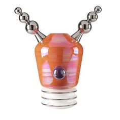 an orange and pink vase with silver balls on it