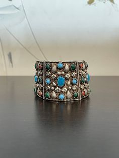 This vintage Navajo bracelet is filled with blue turquoise, green turquoise, coral and a whole lot of creativity and style set in sterling silver. This bracelet is large2 inches wide and wears like an 8-8.5 inch bracelet. it weighs 108.2 grams of silver. Get your statement bracelet on!! Silver Southwestern Cuff Bracelet With Natural Stones, Bohemian Turquoise Sterling Silver Bracelet, Bohemian Blue Sterling Silver Bracelet With Natural Stones, Bohemian Multi-stone Bangle Jewelry, Bohemian Multi-stone Bangle, Southwestern Multi-stone Bracelet Jewelry, Southwestern Style Multicolor Bracelet Jewelry, Collectible Bohemian Turquoise Bracelets, Bohemian Turquoise Bracelets Collectible