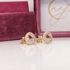 A dainty daily wear earring stud featuring a pave diamond halo around a solitaire round basket in 14k gold. These earrings make for a classic accessory to any look! Perfect for any center stone. A push backing snaps securely into place for easy and safe wear. A staple earring design perfect for an eye catching engagement or anniversary. This earring set also makes a beautiful pair of birthstone earrings for your loved ones. Available in multiple colors of 14K Gold: Yellow, White and Rose. It com Staple Earrings, Halo Diamond Earrings, Designer Silver Jewellery, Round Basket, Halo Earrings, Jewelry Showcases, Birthstone Earrings, Dainty Studs, Earring Stud