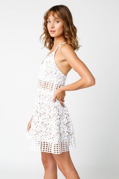 Final Sale - Get it before it's gone! Step into sophistication with the Logan White Lace Fit and Flare Dress! This stunning short lace dress boasts a delicate white lace overlay, with a nude fabric peeking through for a touch of charm. The flattering fit-and-flare silhouette and playful V-neckline. Criss-cross back detailing and adjustable straps make for a perfect fit, while a hidden back zipper adds convenience. Complete the look with some platform heels and you're ready to conquer the day! DE Mini Length Delicate Lace Dress For Brunch, Delicate Mini Lace Dress For Brunch, Flirty Lace Mini Dress With Lace Bodice, Lace Patchwork Mini Dress For Brunch, Delicate Lace Mini Dress For Brunch, Flirty Summer Dress With Delicate Lace, Flirty Summer Dresses With Delicate Lace, Summer Mini Dress With Lace Bodice, Lace Mini Dress With Patchwork For Brunch