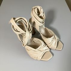 This Luxurious Leather Sandal Topped With Wraparound Ankle Straps Is Raised On A Tall, Sculptural Heel That Brings Individuality To Your Ensembles. Ankle Tie Closure And Made From Linen And Leather. Heel Height: 3.9 Inches. Size 7. New With Tags And In Box. Beige Leather Lace-up Sandals With Round Toe, Beige High Heel Sandals With 4-inch Heel, Beige Closed Toe Sandals For Party, Beige Open Toe Heels, Cream Open Toe Sandals With 4-inch Heel, Beige Heel Strap Sandals For Party, Strap Open Toe Heels Medium Width, Beige Sandals With 4-inch Heel For Summer, Open Toe Medium Width Heels With Strap