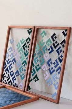 two wooden frames with cross stitch designs on them