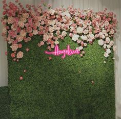 an artificial wall with pink and white flowers