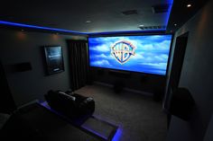 a home theater with blue lighting and curtains