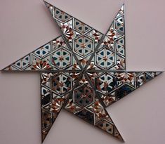 a star shaped mirror hanging on the wall