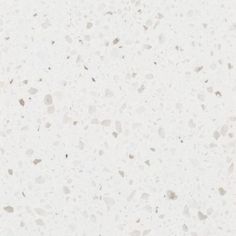 a white counter top with small speckles on it