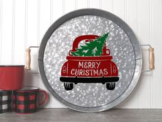 a round metal sign with a christmas tree in the back and merry lettering on it