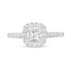 an engagement ring with a cushion cut diamond surrounded by pave diamonds