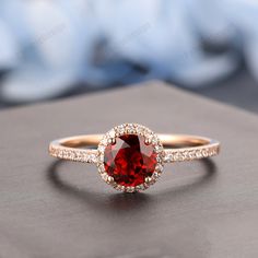 Red Garnet Ring With Halo Setting, Red Diamond Ring With Halo Setting For Proposal, Red Diamond Proposal Ring, Red Solitaire Diamond Ring, Red Solitaire Round Diamond Ring, Red Diamond Ring For Valentine's Day, Red Round Diamond Ring For Valentine's Day, Red Halo Design Ring With Round Cut, Red Halo Ring Gift With Halo Setting