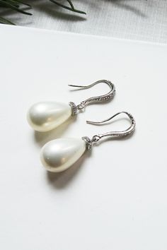 These drop pearl earrings are made with shell pearl teardrop and are perfect for wedding and special occasions. Teardrop Pearl Earrings For Formal Occasion, Elegant White Hypoallergenic Teardrop Earrings, Elegant White Teardrop Pearl Earrings, Pearl White Pear-shaped Teardrop Earrings For Formal Occasions, Formal Pearl Teardrop Earrings, Pear-shaped Sterling Silver Pearl Drop Earrings, Elegant White Pear-shaped Teardrop Earrings, Pearl White Teardrop Dangle Earrings For Formal Occasions, Classic Pearl Teardrop Dangle Earrings