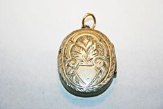 Antique Victorian silver locket, circa 1890s. In good condition, with minor wear and dings commensurate to age; along one edge of the cross, there is a hairline gap in the engraving, where the instrument used to emboss the locket's surface split through the metal. See photos for condition and measurements. Antique Silver Engraved Locket Necklace For Memorial, Engraved Antique Silver Locket Necklace For Memorial, Ornate Engraved Antique Silver Locket Necklace, Victorian Etched Locket Necklace For Memorial, Antique Silver Hallmarked Locket Necklace, Antique Silver Victorian Locket Necklace, Antique Etched Sterling Silver Locket Necklace, Victorian Engraved Locket Necklace For Memorials, Antique Sterling Silver Etched Locket Necklace