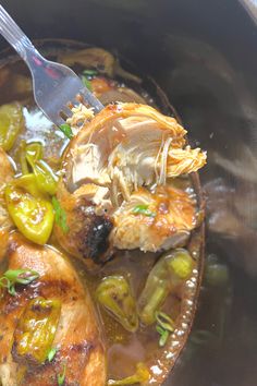 a close up of food in a crock pot with a spoon on top of it