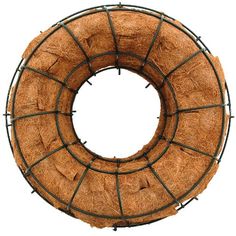 a round hay wreath with metal bars around it, on a white background in the shape of a circle