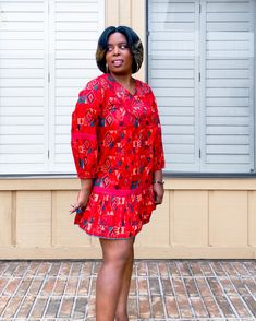 Cotton Dress with vibrant red and green geometric print. V-neck Vibrant & Bold Red & Green print Hand Embroidery Lace trim embroidery and stitching across bodice, steeves and waist Pom Pom detail at hem Tassel tie in back Loose/flowy fit Elastic on bottom of sleeves Dress is short(er) in length. Above the knee. Model is 5'3" wearing a size Medium. Gem Dress, Trim Embroidery, Geometric Print Dress, Sleeves Dress, Embroidery Lace, Green Print, Lace Embroidery, Embroidery And Stitching, Vibrant Red