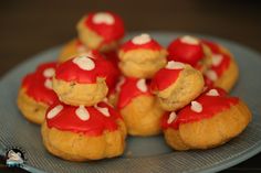 some cookies with red and white frosting are on a plate