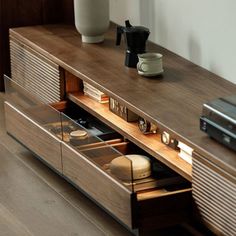 an entertainment center with drawers and coffee maker