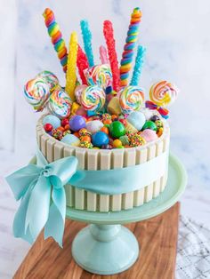 a cake decorated with candy and lollipops