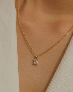 Simple, graceful, and minimalistic, this piece features a rectangular clear crystal CZ stone suspended on the daintiest gold chain. Made with 100% gold-filled materials, she is truly an everyday necklace that you can wear whenever and wherever your heard desires — even in the shower. …………………………………. D E T A I L S • Pendant measures 5 x 13 mm • Tarnish-resistant, waterproof, safe for sensitive skin • 1.5mm width curb chain with spring clasp • 100% 18k gold-filled Elegant Square Pendant Necklace Tarnish Resistant, Elegant Everyday Charm Necklaces, Timeless Rectangular Pendant Jewelry As Gift, Timeless Rectangular Pendant Jewelry Gift, Timeless Rectangular Pendant Jewelry, Everyday Jewelry With Delicate Square Pendant Chain, Everyday Necklace With Delicate Chain And Rectangular Pendant, Classic Necklace With Adjustable Chain As Gift For Her, Elegant Charm Necklace With Delicate Chain For Everyday