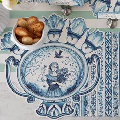 there is a plate with blue and white designs on it next to some croissants