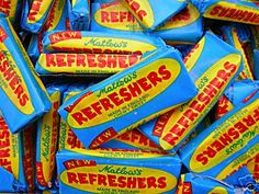 a pile of blue and yellow refreshers candy