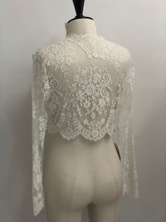 Our delicate French Chantilly lace shrug in ivory will beautifully finish any bridal look. Handmade with sheer French Chantilly lace, our Catherine sheer bolero adds coverage without concealing the details of your gown. Long fitted sleeves complete the look. Wear this delicate piece to add a layer of illusion coverage to a strapless gown. Available in Ivory and Black. Tulle Bolero, French Chantilly Lace, Lace Shrug, Fitted Sleeves, Strapless Gown, Bridal Look, Chantilly Lace, Draped Fabric, French Lace