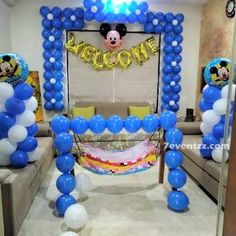 balloon arch with mickey mouse welcome sign and balloons