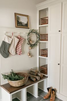 the entryway is decorated for christmas with stockings and wreaths