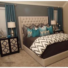 a bedroom with blue and gray decor in it