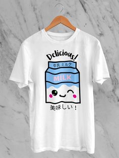 Welcome to our Etsy boutique, where style meets adorable sophistication! Explore our Japanese Kawaii Delicious Milk T-Shirt -- a delightful fusion of Japanese cuteness and contemporary flair. This tee boasts a Delicious Milk illustration featuring irresistibly charming strawberries and the essence of kawaii culture. Crafted from premium materials, this shirt ensures comfort without compromising on style. The Japanese-inspired design adds a touch of playful elegance to your wardrobe, making it a must-have for those who appreciate the art of kawaii fashion. Each shirt is a canvas of sweetness, blending the iconic strawberry motif with the popular Japanese aesthetic. Our Kawaii Delicious Milk T-Shirt is not just a garment; it's a statement. Perfect for casual outings or expressing your unique Cute Cartoon Print Crew Neck T-shirt, Kawaii Funny Print Crew Neck Top, Kawaii Crew Neck Top With Funny Print, White Harajuku Top With Funny Print, Kawaii T-shirt With Cartoon Print Crew Neck, Cute White T-shirt With Letter Print, Cute Crew Neck T-shirt, White Casual T-shirt With Cute Design, Casual White T-shirt With Cute Design