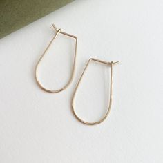 These 14k gold hoops are perfect for everyday wear. Named after the Greek goddess of wisdom and strength, these earrings will elevate your look each time you reach for them. Each purchase comes with an elegant, vegan leather box for storing + caring for your jewelry. DETAILS14k Solid Gold | 1 1/8" in length, 5/8" wide Minimalist 14k Gold Teardrop Huggie Earrings, Gold 14k Threader Earrings For Everyday, Everyday 14k Gold Threader Earrings, 14k Gold Filled Yellow Gold Threader Earrings For Everyday, Gold Sterling Silver Hoop Earrings For Everyday Elegance, Gold-toned Sterling Silver Hoop Earrings For Everyday Elegance, Everyday 14k Yellow Gold Filled Threader Earrings, Yellow Gold Teardrop Hoop Earrings For Everyday, Everyday Yellow Gold Teardrop Hoop Earrings