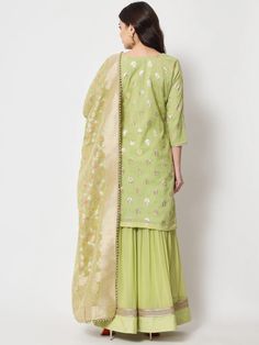 This is a beautiful 3-piece suit set. It comes with straight cut kurta with foil print detailing has 3/4th sleeves, v neck & short length teamed with flared sharara pants and a georgette banarasi dupatta. 3-piece set Color- Pista Green Work- Foil Print Detailing Kurti Length - 36 inch Kurta Fabric-Chanderi Bottom Fabric -Chinon Dupatta Fabric - Georgette Banarasi Dupatta. Sleeves-3/4th Sleeves Neck-V Neck Care - Dry Clean Pista Green Cotton Silk Palazzo Set With Straight Kurta, Pista Green Palazzo Set With Gota Work, Banarasi Silk Kurta With Gota Work, Festive Pista Green Cotton Silk Sharara, Pista Green Lehenga With Straight Kurta For Ladies, Pista Green Salwar Kameez With Gota Work, Pista Green Chanderi Sets With Gota Work, Unstitched Cotton Silk Sets With Gota Work, Transitional Pista Green Sharara With Straight Kurta