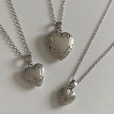 SIZE: chain length is 40cm plus a 5cm extension piece. in the images i am wearing the locket necklace on the last clasp. - small locket: 1 x 1 cm - medium locket: 1.3 x 1.3 cm - large locket: 2 x 2 cm MATERIAL: chain, rings, and charm are all rhodium plated brass (hypoallergenic & tarnish resistant). all materials are from ethical and sustainable sources. POSTAGE INFO: this necklace is handmade with love by me in perth, western australia. PACKAGING: all jewellery is placed inside a storage box and packaged in cardboard and paper packaging. STORAGE & CARE: store your jewellery in a cool, dry place, away from moisture. although all earrings are tarnish resistant, try to avoid contact with chlorinated water and perfumes. MATCHING EARRINGS: https://www.etsy.com/au/listing/1033665816/ Luxury Silver Locket Necklace, Cheap Spiritual Locket Necklace, Cheap Silver Round Locket Necklace, Small Silver Locket, Cute Necklaces Silver, Locket Necklace Aesthetic, Heart Locket Necklace Silver, Heart Lock Necklace, Locket Necklace Silver