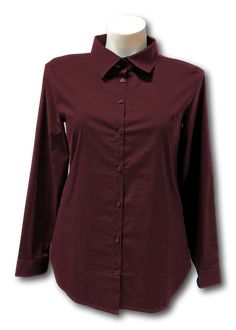 Fitted long sleeved shirt in woven stretch cotton fabric with a collar. Buttons down the front, with french darts allowing volume at the bust without pulling buttons apart. Gently rounded hem. Darted at the bust and down the princess seams in the back. Buttons on the cuff. Machine wash warm, hang dry Business Casual Stretch Button-up Blouse, Stretch Button-up Blouse For Business Casual, Cotton Long Sleeve Shirt With Covered Buttons, Long Sleeve Cotton Shirt With Covered Buttons, Stretch Solid Color Blouse With Button Closure, Solid Stretch Blouse With Button Closure, Stretch Solid Blouse With Button Closure, Stretch Blouse With Button Closure, Long Sleeve Stretch Shirt For Office