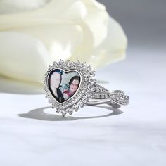 Celebrate life's biggest milestones or those everyday moments with a personalized photo ring for any occasion. Crafted in sterling silver, it features a heart shape at the center with the popular twist design on the shank which set with shimmering round cut stones. Whether you're crafting a personal keepsake or designing a one-of-a-kind gift, this beloved heart photo ring reveals the perfect surprise.Material: Plating Color: Customizable Silver Engraved Ring For Valentine's Day, Sterling Silver Fine Jewelry Heart Ring For Anniversary, Engraved Ring For Valentine's Day Anniversary, Personalized White Gold Rings For Valentine's Day, Personalized Sterling Silver Heart Ring Fine Jewelry, Personalized Sterling Silver Heart Ring, Elegant Customizable Rings For Valentine's Day, Silver Heart Ring With Diamond Accents For Anniversary, Personalized Ring For Anniversary Gift On Valentine's Day