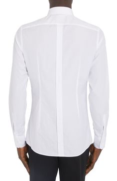 Channel a trim, tailored aesthetic in this cotton button-up shirt that features a crisp point collar and long sleeves. 30 1/2" length (size 40) Front button closure Point collar Long sleeves with button cuffs 100% cotton Dry clean or machine wash, line dry Made in Italy Men's Designer Clothing Designer White Shirt With Concealed Placket, White Long Sleeve Dress Shirt With Concealed Placket, Designer Slim Fit Long Sleeve Shirt, Long Sleeve Cotton Dress Shirt With Concealed Placket, Cotton Dress Shirt With Concealed Placket, Business Dress Shirt With Concealed Placket, Designer Slim Fit Long Sleeve Dress Shirt, Fitted Collared Shirt With Functional Buttons, Luxury Long Sleeve Cotton Dress Shirt