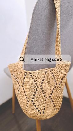 a handbag sitting on top of a chair with the words market bag size s