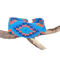 Lovely handmade Huichol beaded bracelet, southwest style,  tribal symbol pattern, light blue, lavender, orange and glitter blue colour, from our Fair Trade partners in Mexico.  Size is approx. between 18.5long cm by 2.5 cm wide. Please also visit my new shop, BALI COCONUT BY ROSA made in Fairtrade partnership with fine Balinese artisans and featuring all natural jewellery: https://www.etsy.com/uk/shop/BaliCoconutbyRosa Spend over $35 US Dollars with us and receive FREE postage for orders to the Bohemian Blue Bracelets With Colorful Beads, Blue Bohemian Bracelets With Colorful Beads, Southwestern Style Multicolor Handwoven Beaded Bracelets, Blue Artisan Adjustable Beaded Bracelet, Bohemian Blue Hand-strung Bracelets, Adjustable Artisan Blue Beaded Bracelets, Adjustable Blue Artisan Beaded Bracelets, Southwestern Style Large Beads Bracelet For Festivals, Bohemian Woven Bracelets With Round Beads