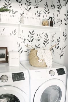 a washer and dryer sitting next to each other in front of a wall