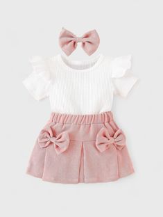 Dress your little one in timeless elegance with our Baby Girl Solid Color Ruffle Hem Top and Corduroy Bow Pleated Skirt Set. This charming outfit features a solid color top with delicate ruffle hem detailing and a pleated corduroy skirt adorned with a cute bow. Perfect for any occasion, your baby girl will look adorable and feel comfortable all day long. Woman Costumes, Pleated Skirt Set, Onesie Costumes, Bodysuit And Skirt, Baby Boy Shirts, Bow Skirt, Baby Outerwear