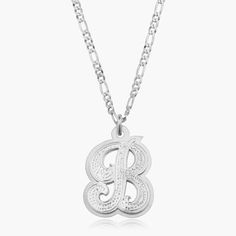 Our popular Double Plated Iced Out Initial Necklace boasts a chic and elegant design, handcrafted to perfection. The model showcases the necklace with an 18-inch Figaro chain (see video for reference). You can personalize this item with Letters, Numbers, and Roman Numerals and choose from chain lengths of 14", 16", 18", and 20". Each chain features a lobster clasp closure for secure wear.Chain width:Cuban Chain - 3.7 mmFigaro Chain - 3 mm Silver Pendant Initial Necklace In Fine Jewelry, Engraved Initial Pendant Chain Necklace As Gift, Engraved Initial Pendant Chain Necklace For Gifts, Luxury Hallmarked Initial Pendant Necklace, Classic Formal Charm Necklace, Gift White Gold Initial Necklace With Polished Finish, Silver Sterling Silver Initial Necklace, White Gold Initial Necklace With Polished Finish For Gift, Engraved Sterling Silver Chain Necklace For Anniversary